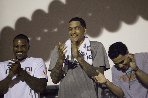 Junior Erik Swoope, senior Julian Gamble and sophomore Shane Larkin of the Men's Basketball team laugh onstage during a thank you ceremony hosted by Category 5. Coach Larranaga and the team were presented with a plaque and a basketball signed with messages from the students. Larranaga thanked the students for their high attendence this season by suggesting that they were the "6th man on the team." Monica Herndon // Assistant Photo Editor