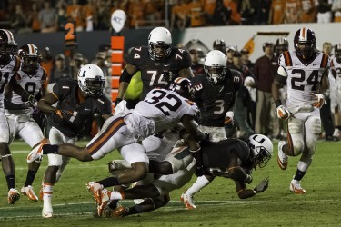 Dallas Crawford (25) gets tacked by the Virginia Tech defense during Saturday's Homecoming game. Nick Gangemi // Assistant Photo Editor