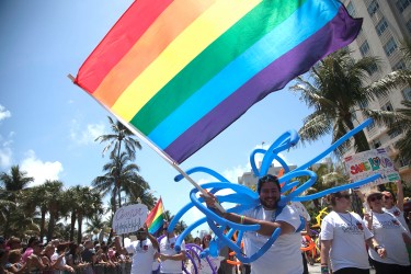 A member of Coral Gables United Church of Chirst walks with members of his congregation down Ocean Drive in South Beach during the 5th annual Pride Parade held in April 2012. File Photo