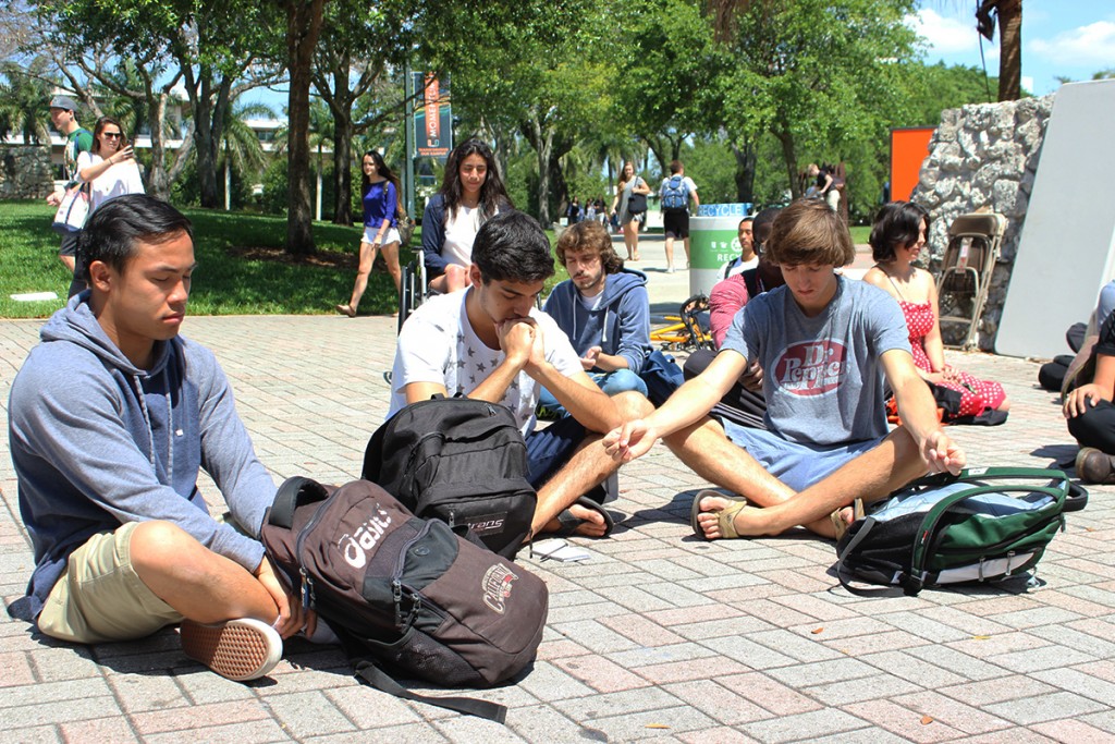 Students sit for peace at the UC Rock Monday afternoon. Giancarlo Falconi // Staff Photographer
