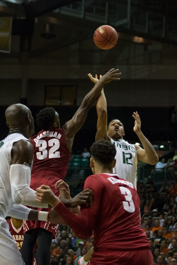 Freshman James Palmer (No. 12) attempts a shot during Saturday's game against Alabama, as part of the Hurricane's NIT run. The Canes won 73-66 and will continue to the next round. Victoria McKaba // Staff Photographer