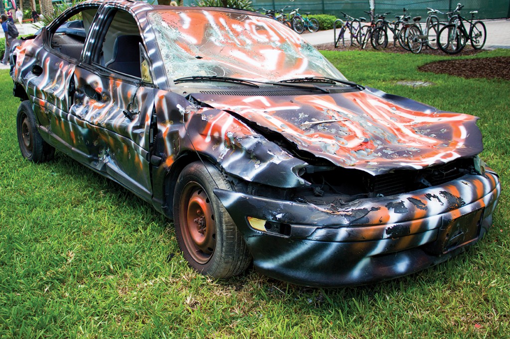 In preparation for this Saturday's football game, a car decorated to resemble University of Virginia is smashed Wednesday afternoon. Hallee Meltzer // Photo Editor