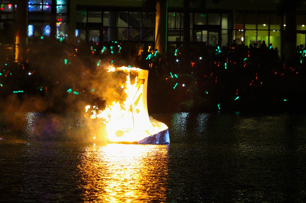 The annual boat burning event on Lake Osceola took place Friday evening during Hurricane Howl. A University of Miami Homecoming tradition, if the mast falls before the boat sinks it is predicted the 'Canes will win the Homecoming football game. Hallee Meltzer // Photo Editor