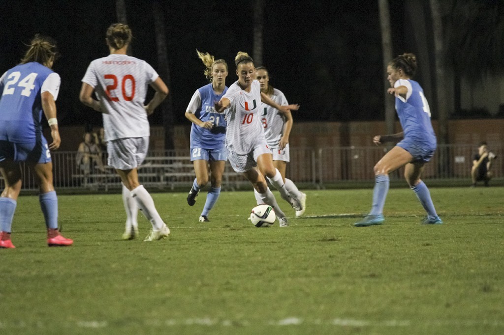 Senior and team co-captain Natalie Moik (10) drives past North Carolina defenders during Saturday's game at Cobb Stadium. The Canes were defeated 2-0 during the final match of their season. Kawan Amelung // Staff Photographer