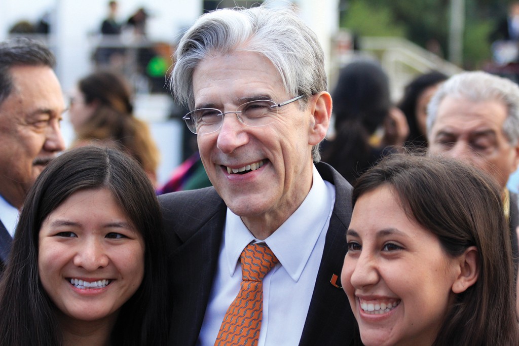 Newly inaugurated President Julio Frenk poses with seniors Megan Lee (left) and Miranda Goot (right) during the community reception on the Lakeside Patio Friday afternoon, which followed his inauguration ceremony. Victoria McKaba // Assistant Photo Editor