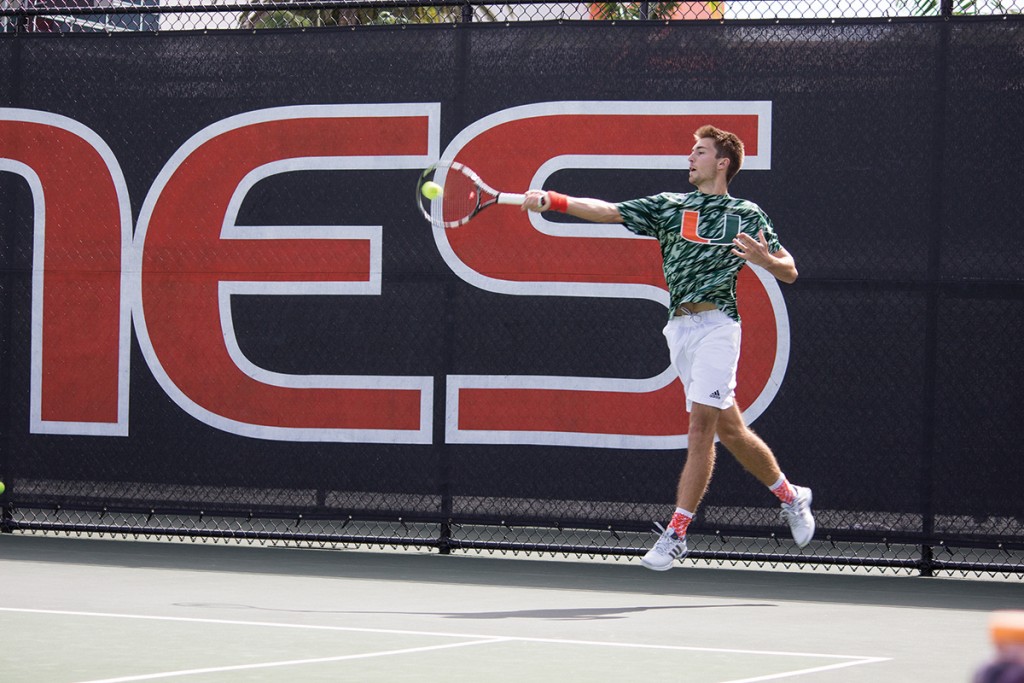Sophomore Piotr Lomacki takes a forehand shot during his singles match Saturday afternoon at the Neil Schiff Tennis Center. The Hurricanes beat Troy University 4-3. Giancarlo Falconi // Staff Photographer