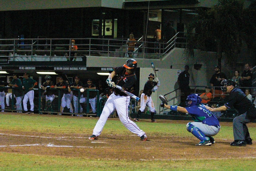 Junior catcher Zack Collins (0) hits a home-run to give the Canes the go-ahead run during baseball’s 6-2 win over FGCU Wednesday night at Alex Rodriguez Park at Mark Light Field. Victoria McKaba // Assistant Photo Editor