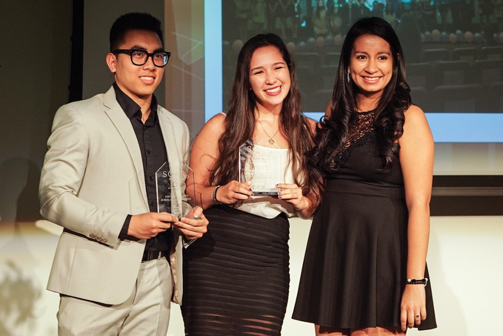 Juniors Quang Nguyen and Daniela Perez accept the People's Choice Award on behalf of their respective organizations, the Chinese Students Scholars Association and the Association of Commuter Students, at the SOAR Awards Wednesday evening in the Shalala Student Center. Hunter Crenian // Contributing Photographer