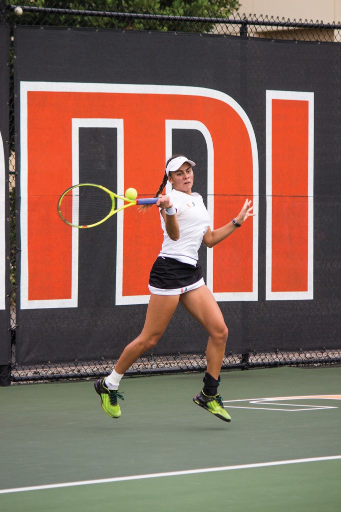 Freshman Ana Madcur hits a forehand shot during the women’s tennis 6-1 win over Syracuse Friday afternoon at the Neil Schiff Tennis Center. Madcur had a 6-2, 6-1 win over Louisville’s Olivia Boesing to finish her regular season 14-3 in singles. The Hurricanes’ shutout the Cardinals 7-0. Shreya Chidarala // Staff Photographer 