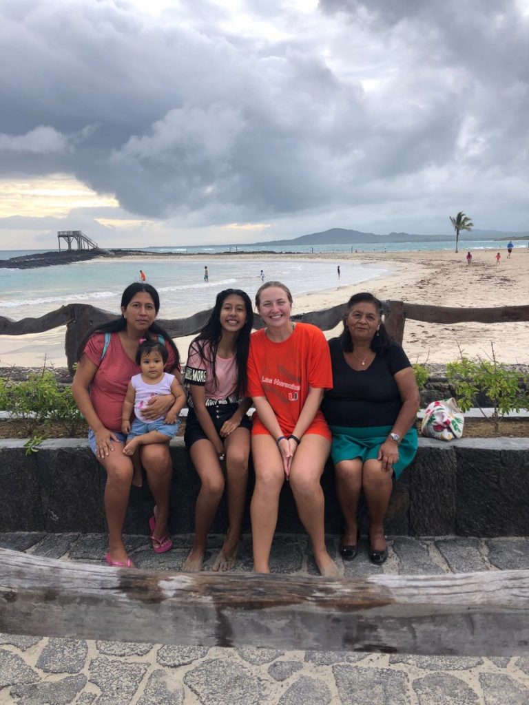 Cassidy Renninger, poses by the beach with her host family on Isabela Island. Students were each paired with host families for the duration of the program.