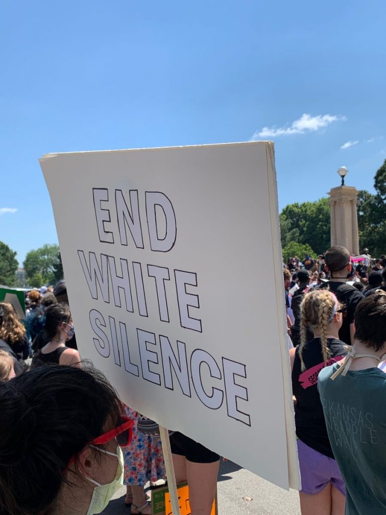 A protestor holds a sign reading “End White Silence” during a demonstration outside of the Arkansas State Capitol in Little Rock, AR on Sunday, June 7, 2020.