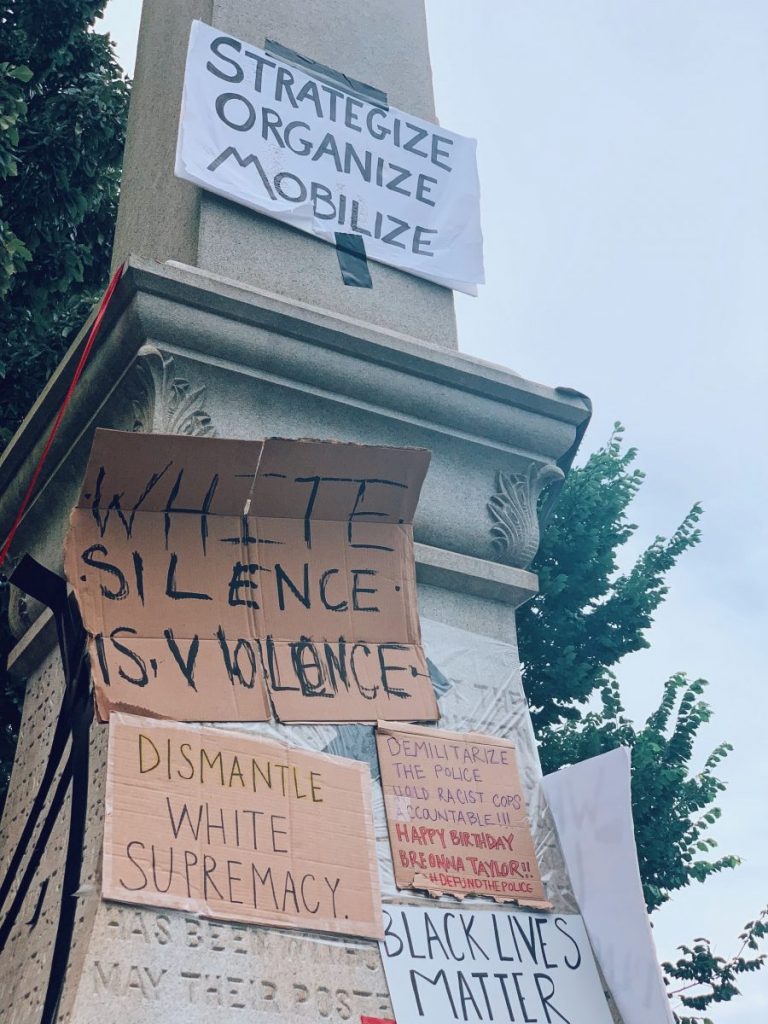 Signs calling for change adorn a Confederate monument during protests in Decatur, GA on Friday, June 5, 2020.