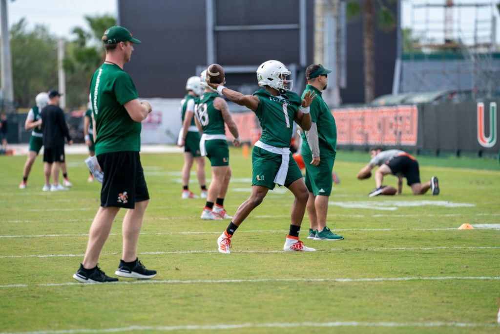 Redshirt Senior quarterback D’Eriq King throws the ball during the second day of Miami’s spring training as Offensive Coordinator Rhett Lashlee watches on March 3 at the Greentree Practice Facility.