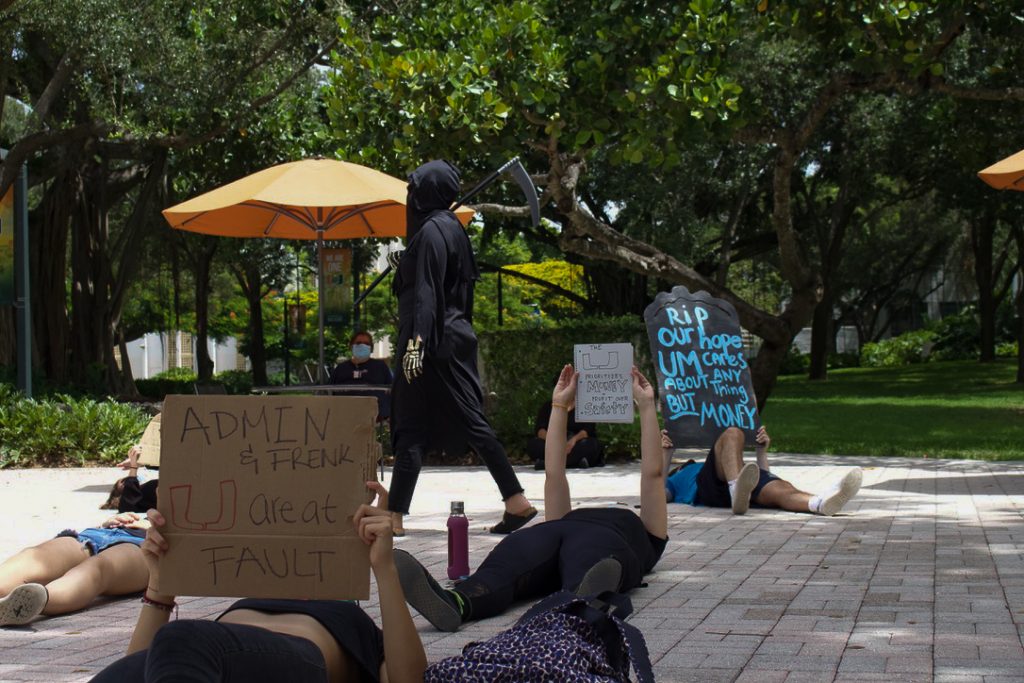 Members of the UM community hold up "gravestones" and dress in all black on Friday, Sept. 4 at the Rock Plaza. Students and staff protested to raise awareness about issues with university actions during the COVID-19 Pandemic.