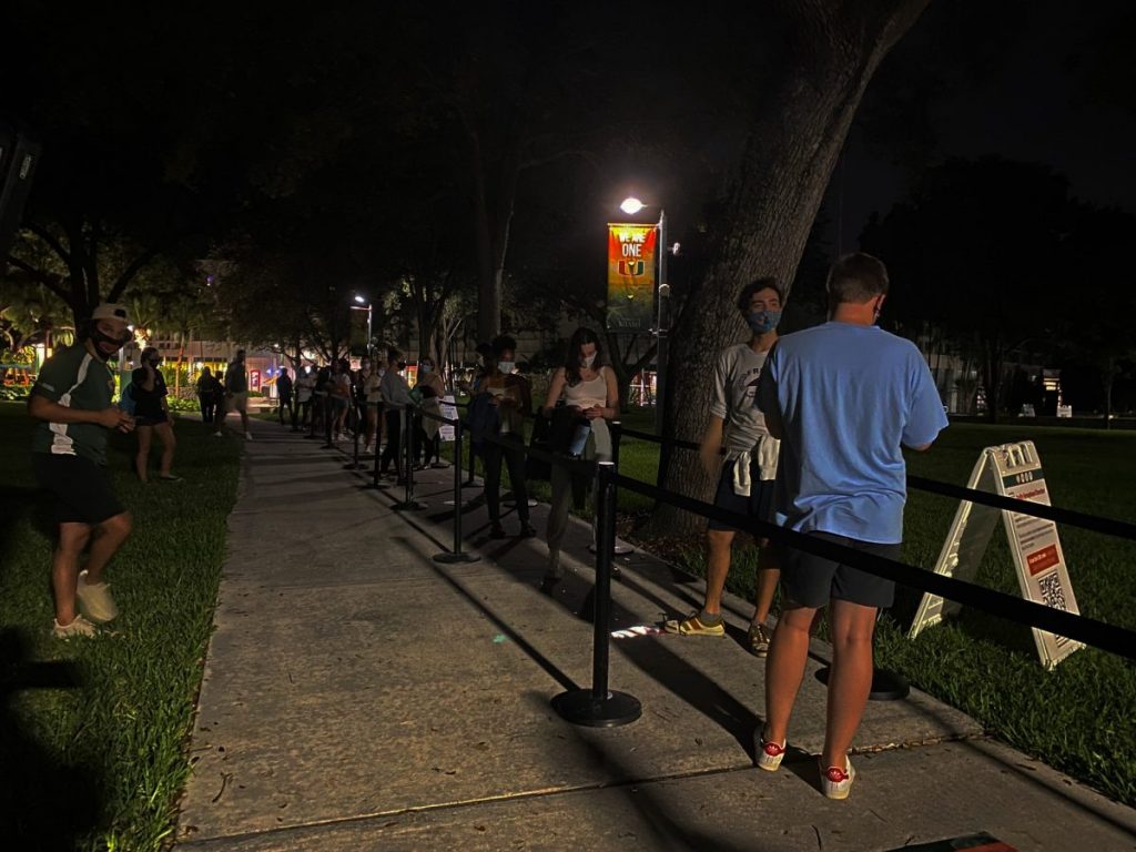 Students wait in line to watch the presidential debate on the Foote Green on Tuesday, Sept. 29, 2020. The first 100 attendees received a free beach mat, beach towel, and a "Canes Vote" wristband.