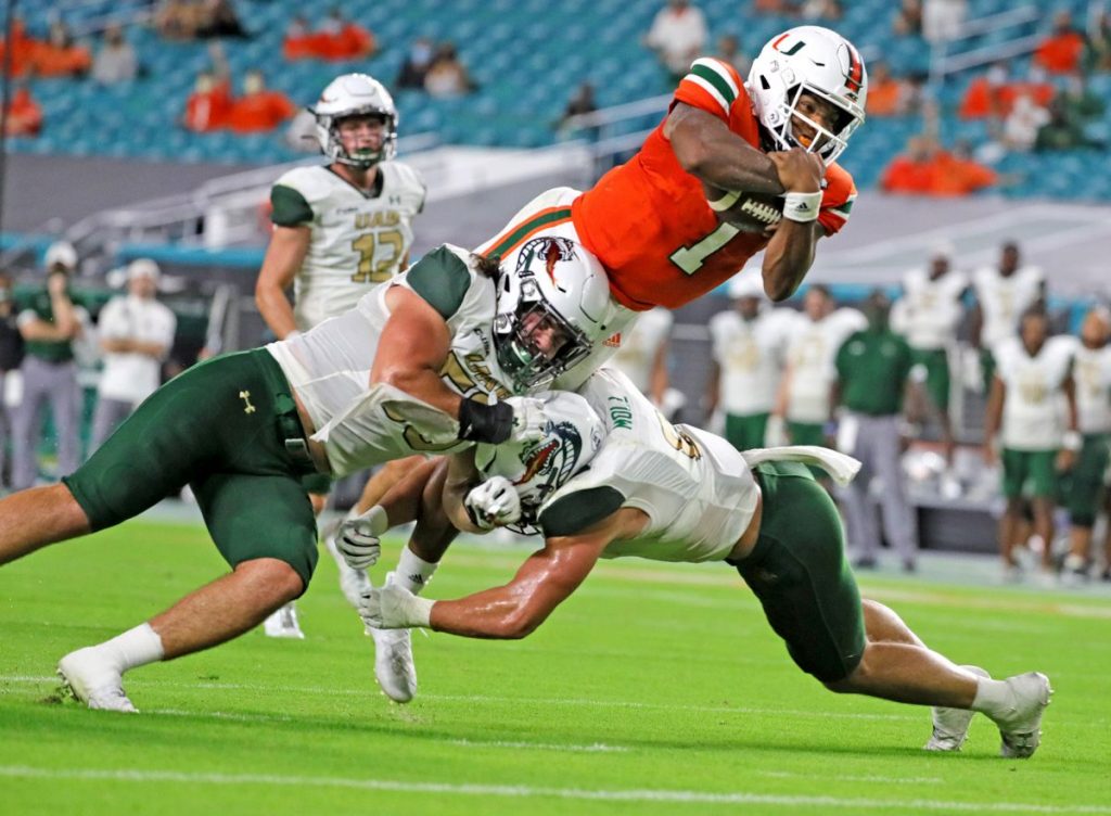 Senior quarterback D'Eriq King (1) leaps for a second-quarter touchdown as the University of Miami hosts the UAB Blazers at Hard Rock Stadium in Miami Gardens on Thursday, September 10, 2020.
