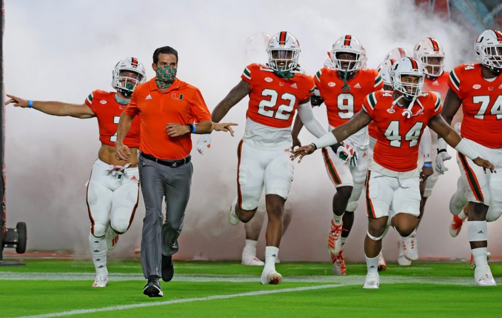 Coach Manny Diaz runs out of the tunnel with the team as the University of Miami hosts the UAB Blazers at Hard Rock Stadium in Miami Gardens on Sept. 10.