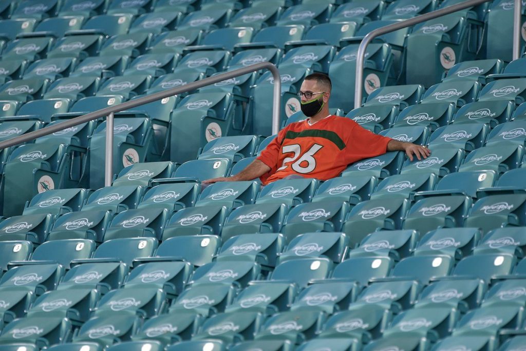 A Hurricanes fan practices social distancing while watching the ‘Canes take on the UAB Blazers at Hard Rock Stadium on Thursday, September 10.