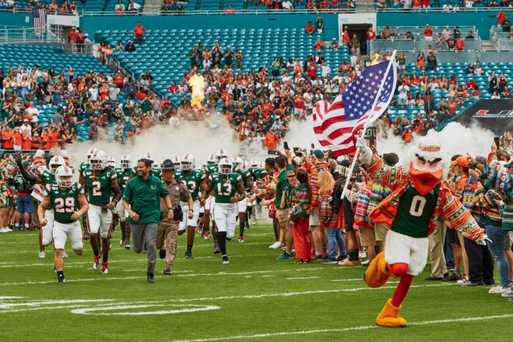 The Canes football team, led by Sebastian, charge through the smoke at Hard Rock Stadium before Miami's game versus Louisville on Nov. 9, 2019.