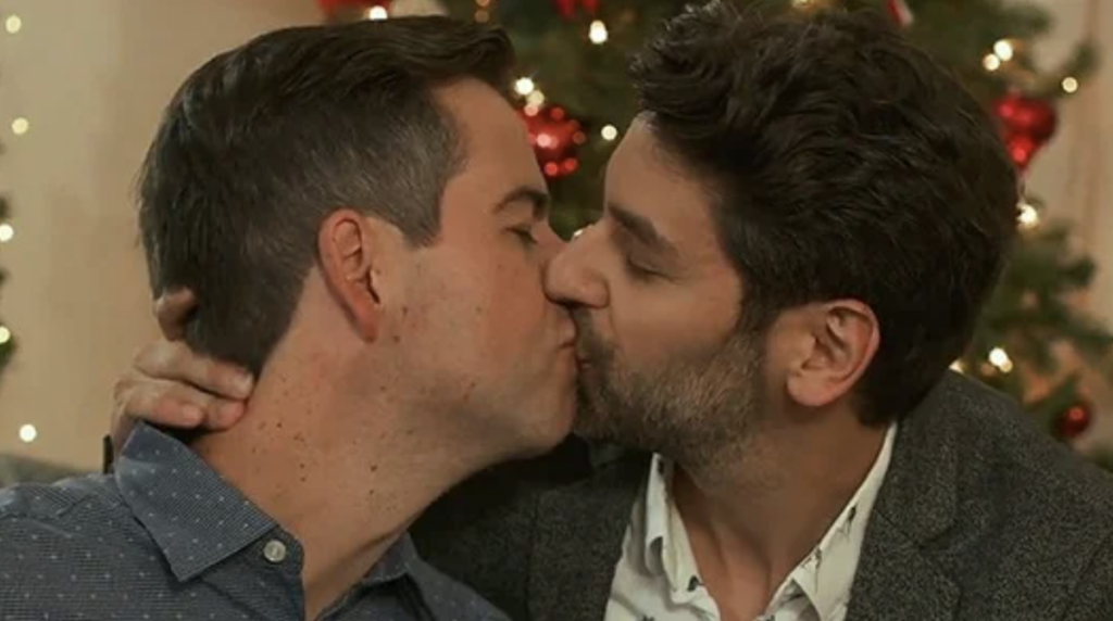 Actors Brian Sills and Mark Ghanimé share a kiss in the 2019 Lifetime film "Twinkle All the Way," the very first appearance an LGBTQ+ kiss in the network&squot;s history.