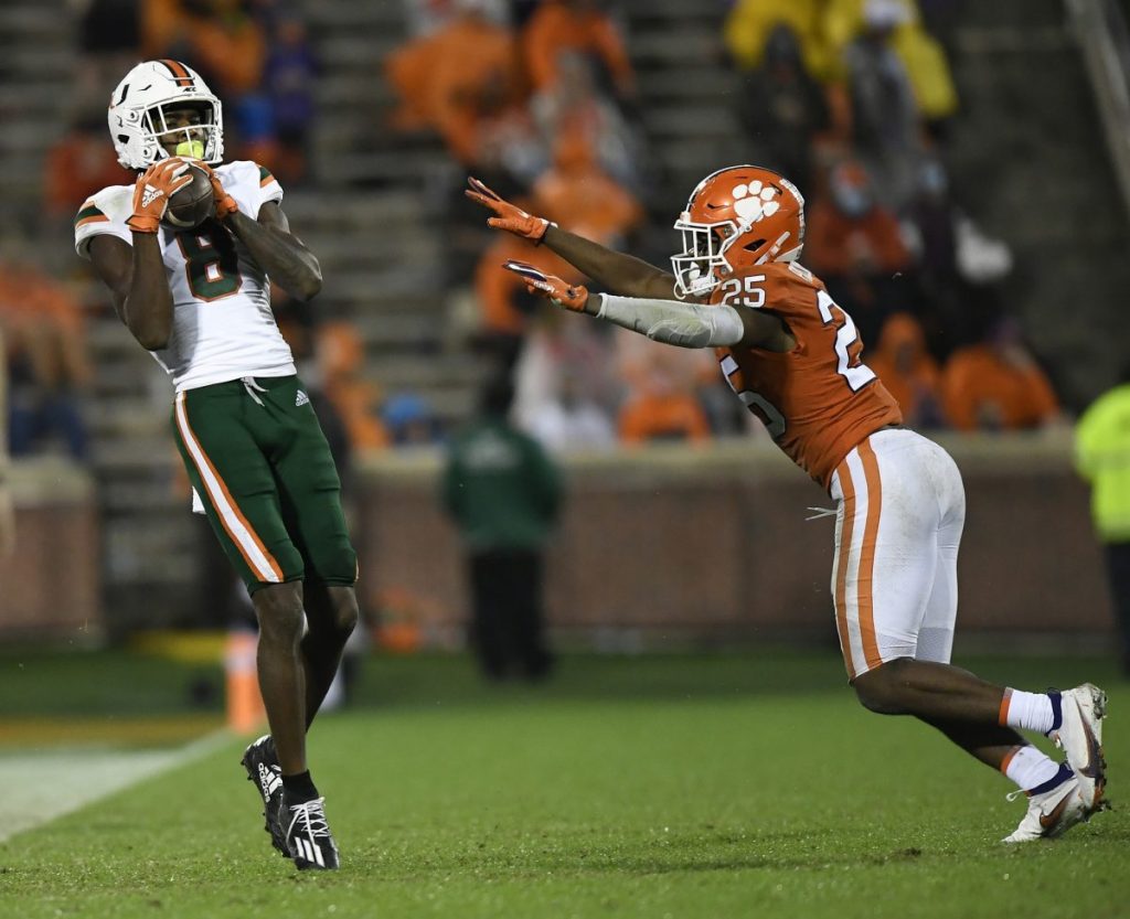 Wide Receiver Dee Wiggins (8) catches a pass past Clemson defensive back Jalyn Phillips (25) during the 3rd quarter of Miami's game versus Clemson at Memorial Stadium in Clemson, South Caroline on Saturday, October 10.