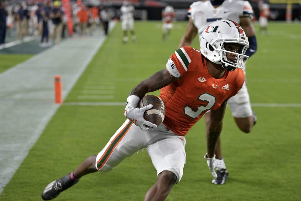 Receiver Mike Harley catches a touchdown pass in front of Virginia linebacker Noah Taylor during the first half of Miami's game versus Virginia at Hard Rock Stadium in Miami Gardens, Florida on Saturday, Oct. 24.