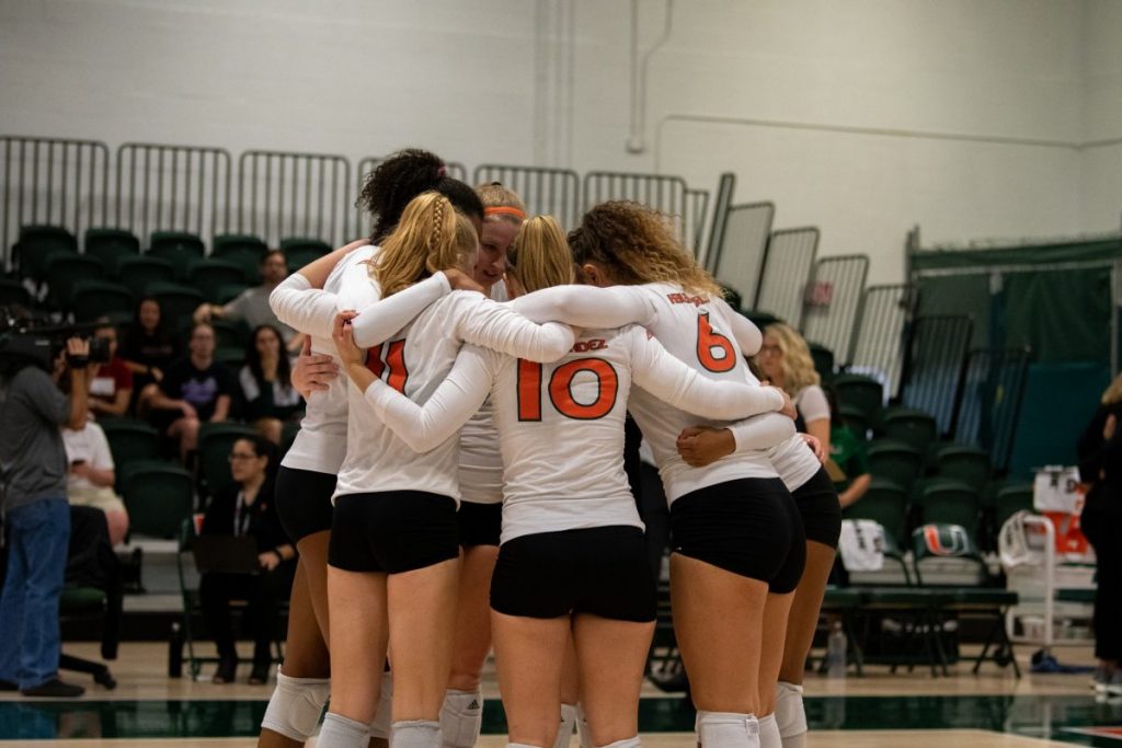 Members of the Canes volleyball team huddle during their match against NC State on Nov. 15, 2019 in the Knight Sports Complex.