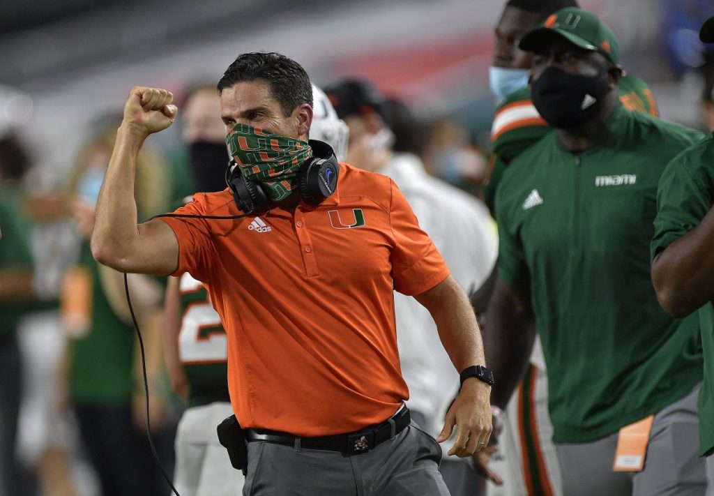 Manny Diaz celebrates a touchdown against Florida State during the first half of Miami's game versus Florida State on Sept. 26, 2020. This season, all sideline personnel wear face coverings to prevent the spread of Covid-19.