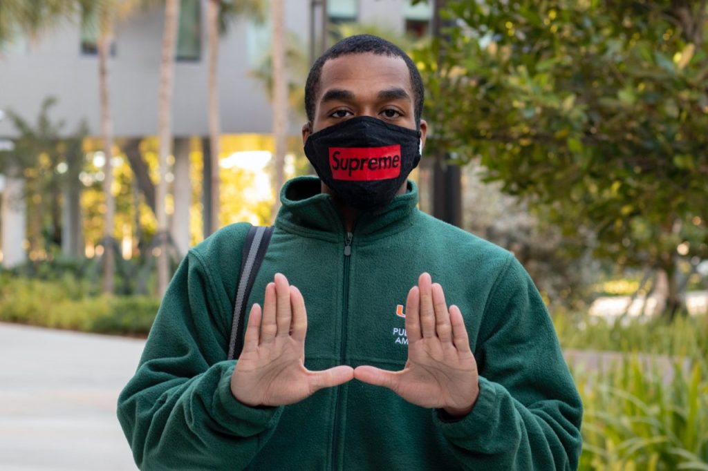 Junior Public Health Ambassador DeAndre Athias poses at Lakeside Village during his shift on Feb. 3. Public Health Ambassadors enforce COVID regulations by encouraging social distancing, wearing face coverings and other safety protocol.