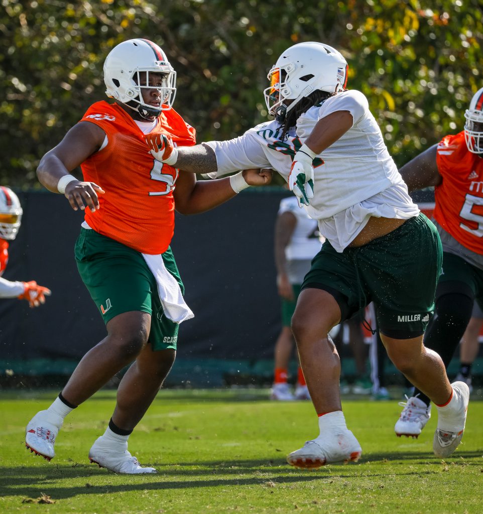 Offensive lineman DJ Scaife, Jr. (left) and defensive lineman Jordan Miller (right) participate in a drill during spring practice.