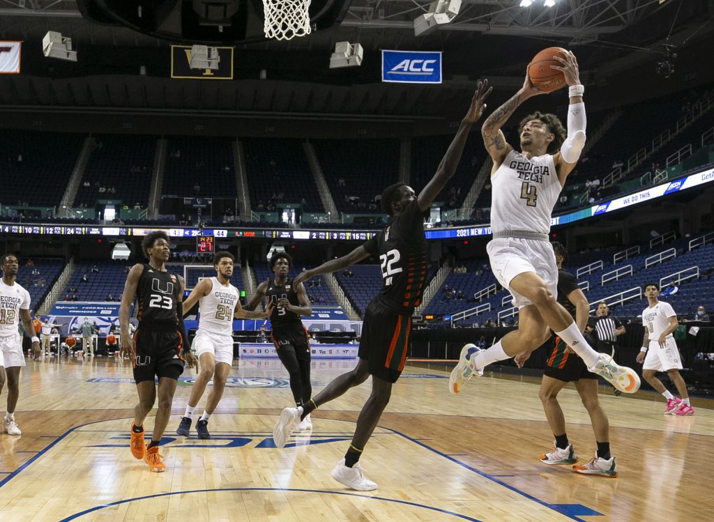 Georgia Tech's Jordan Usher (4) shoots as Miami’s Deng Gak (22) defends during Georgia Tech’s 70-66 victory over Miami in the quarterfinals of the ACC Men’s Basketball Tournament in Greensboro, N.C., Thursday, March 11, 2021.