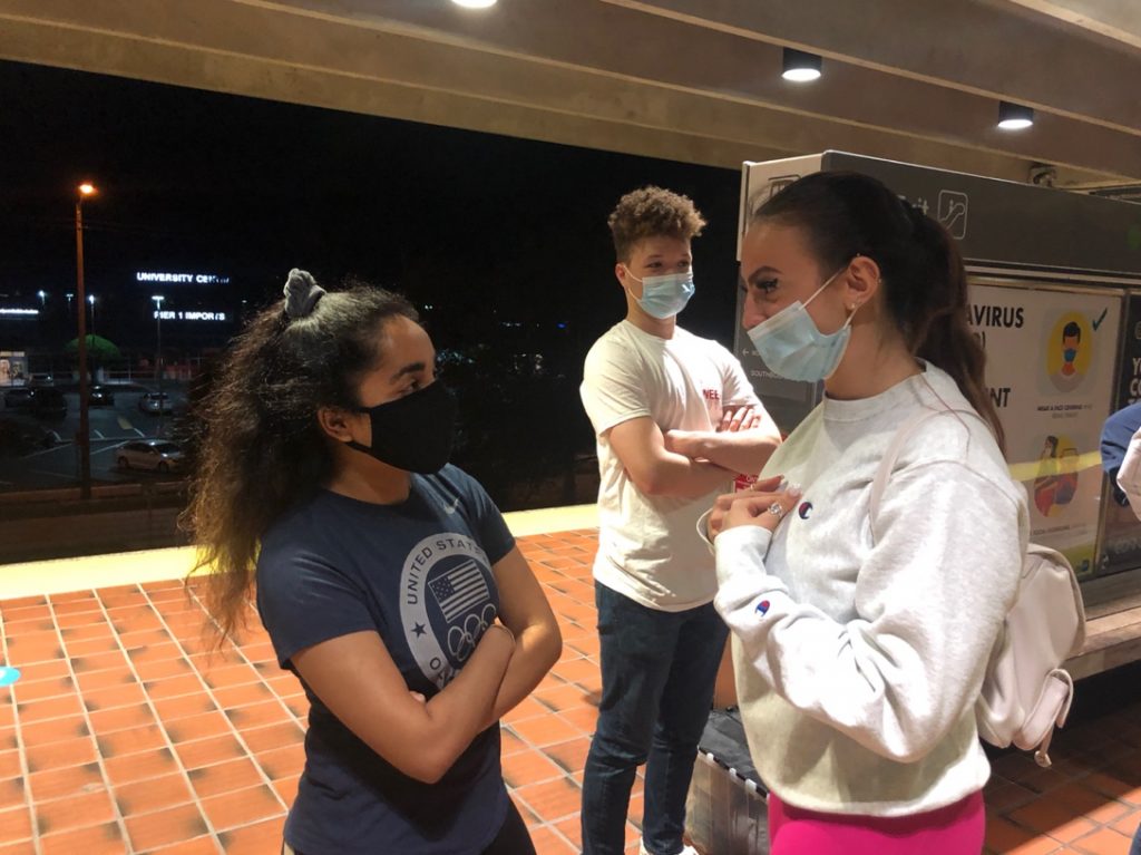 STEP e-board members Preeti Shukla, left, and Nicole Ivanova, right, speak about STEP’s volunteer event while waiting for the metro to arrive with STEP volunteer Joseph Wicker on March 19 at University Metrorail Station.