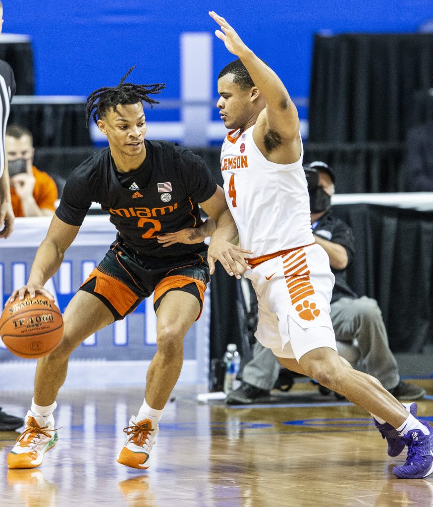 Miami's Isaiah Wong is guarded by Clemson's Nick Honor during an NCAA college basketball game in the second round of the Atlantic Coast Conference tournament in Greensboro, N.C., on Wednesday, March 10, 2021.