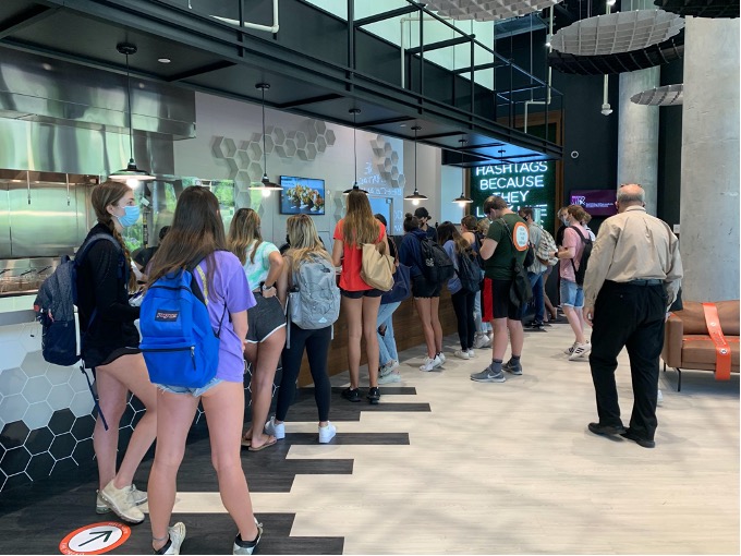 After ordering, students wait at the counter to pick up their waffles. During the lunchtime rush, some students waited a half hour or more between ordering and receiving their food.