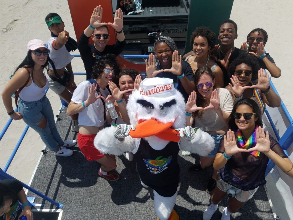 Students show pride at the annual Miami Beach Pride along with University of Miami Mascot Sebastian. Miami Beach, 2019.