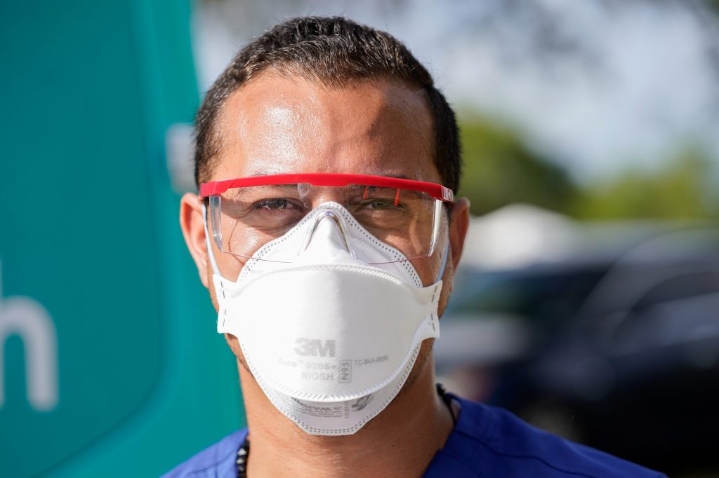 Emergency Medical Technician Jackson Salazar wears personal protective equipment at a county-supported pop up site at Homestead Air Reserve Park, on Wednesday, March 31, 2021.