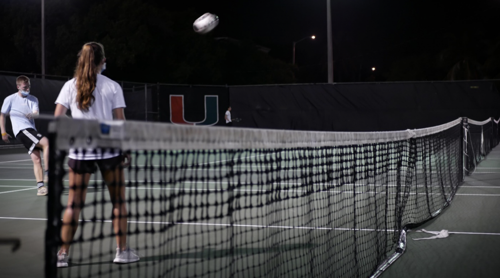 Eben Butler, left, sends the ball back to his opponent at the UM tennis courts on March 31.