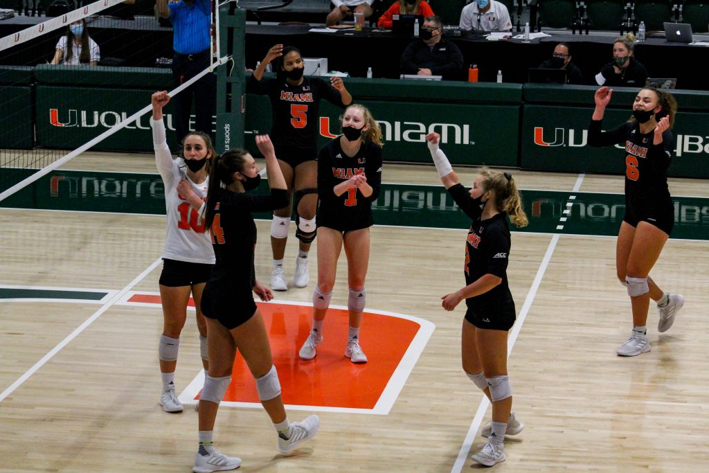 The Hurricanes cheer after winning a point during their match against the UNC Tar Heels on April 3. It was the last match of the spring season for Miami.