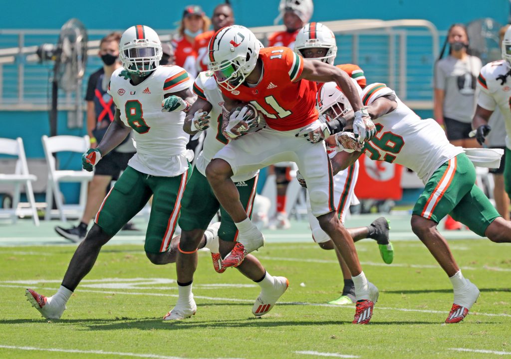 Miami Hurricanes wide receiver Charleston Rambo (11) gains yardage after a pass reception during spring game at Hard Rock Stadium in Miami Gardens on Saturday, April 17, 2021.