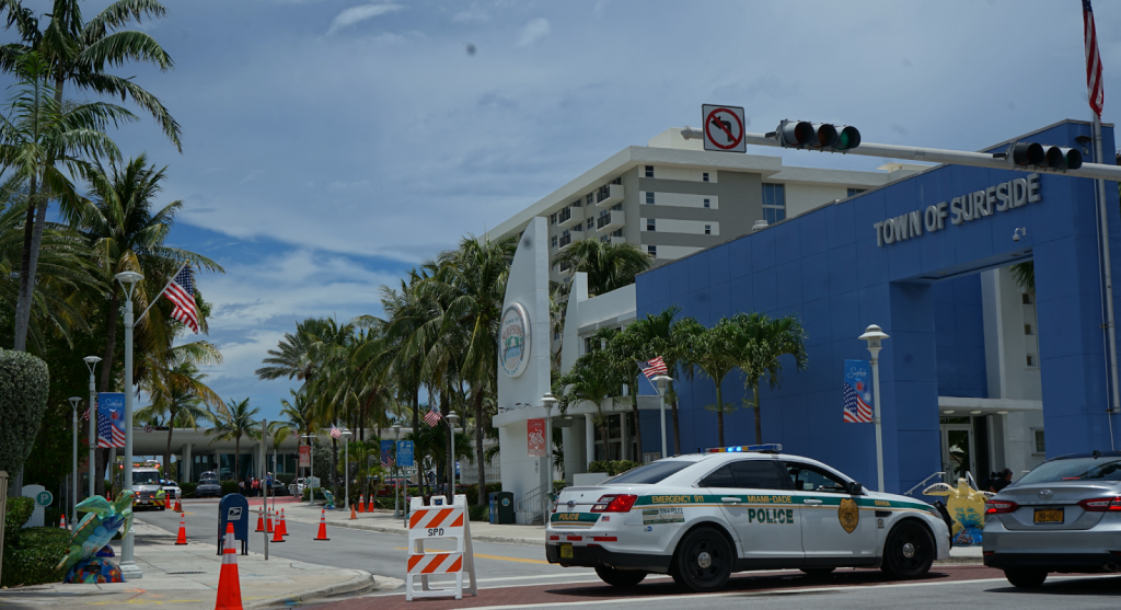 The Surfside Tourist Information Center sits directly in front of the ongoing support effort at the Surfside Community Center on Saturday, June 26. County police have blocked off this street, along with many of Surfside’s now heavily congested roadways.