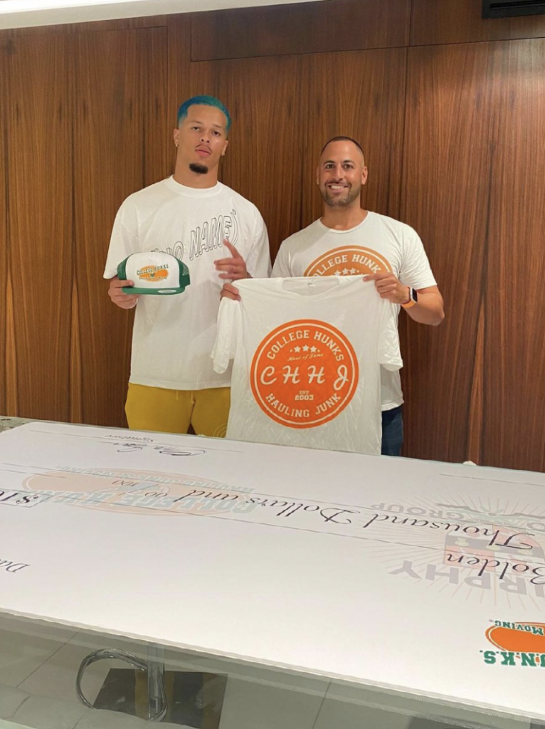 King's teammate and fellow senior Bubba Bolden (left) is pictured after signing an endorsement deal with College Hunks Moving Junk.
