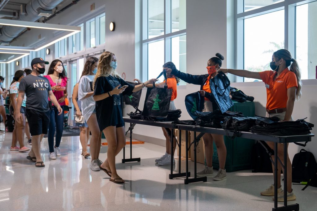 Students receive bags on their way in to Canefest 2021 at the Watsco Center on Aug. 22, 2021. The bags are used to carry branded merchandise that clubs and organizations hand out.