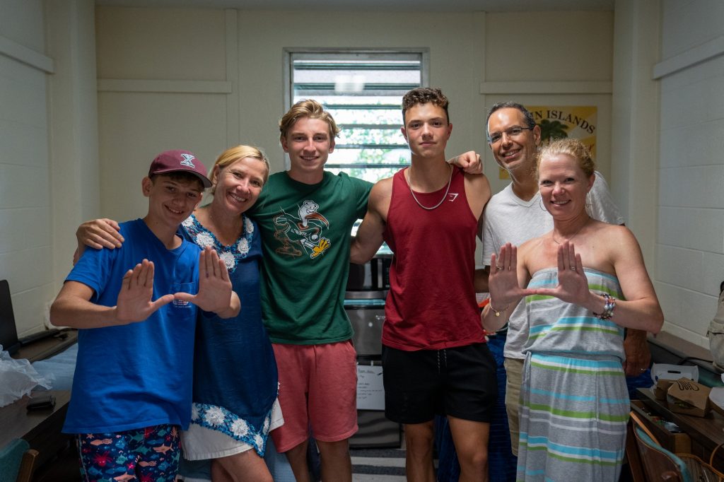 Jack Bettex and roommate Peter Commisso pose with family while settling in their room in Stanford Residential College on Aug. 17, 2021.