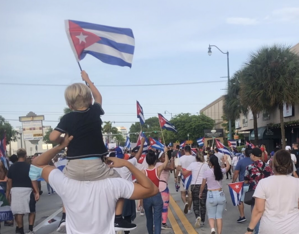 A young boy waves the Cuban flag during a march on July 11th on Calle Ocho in Miami, Florida in support of the protests in Cuba.