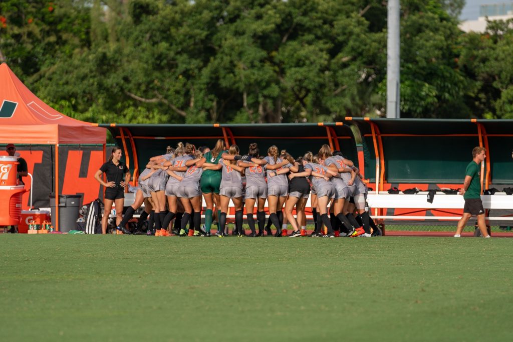 Canes Women’s Soccer players huddle up before their match versus FAU at Cobb Stadium on Aug. 22, 2021