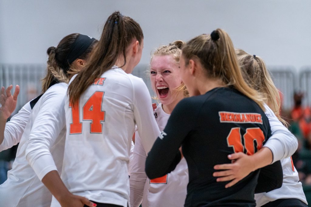 Canes Women’s Volleyball players celebrate scoring a point during their game versus UMBC in the Knight Sports Complex on Aug. 29, 2021.