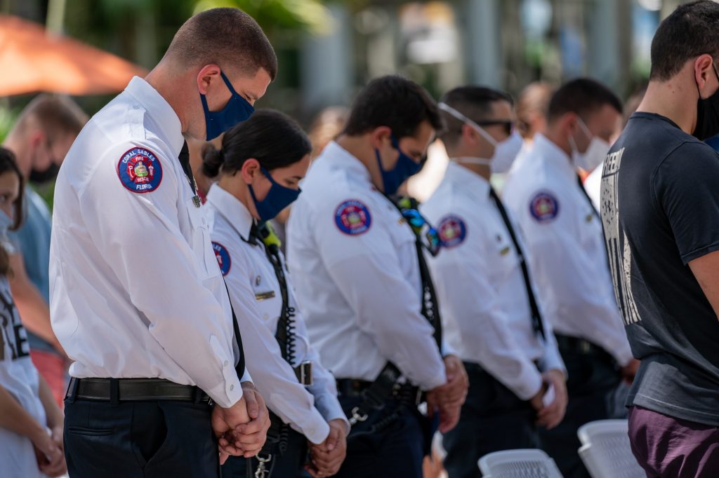 Members of Coral Gables Fire Rescue observe a moment of silence during the 9/11 National Day of Service and Remembrance Memorial at the Rock Plaza on Sept. 10, 2021.