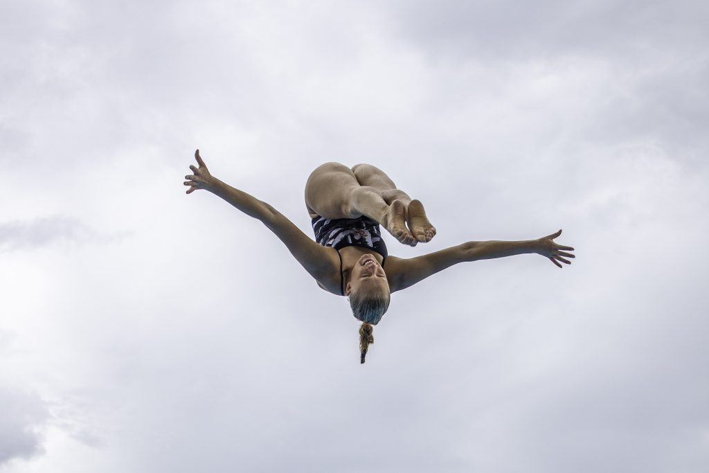 Sophomore Emma Gullstrand dives off of the 10 meter platform during practice on Monday Sept. 13 at the UC Pool.