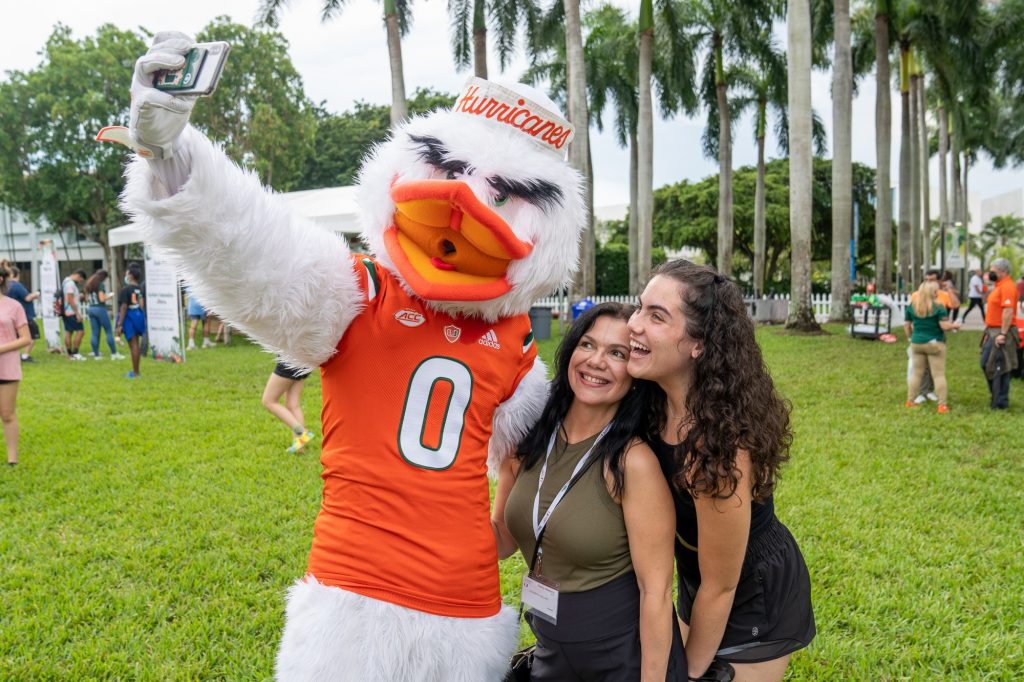 Freshman Lisa Sellers and mother Jade Sellers take a selfie with Sebastian the Ibis during the Family Weekend Pep Rally & BBQ on the Foote Green on Sept. 24, 2021.