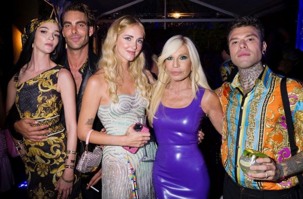 Donatella Versace poses with attendees in Milan